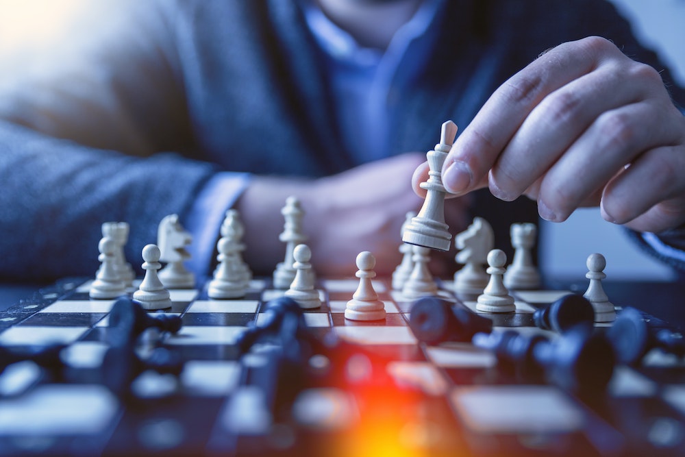 Blog header image of a man playing chess for the Sage for the CFO and Controller article from SWK Technologies