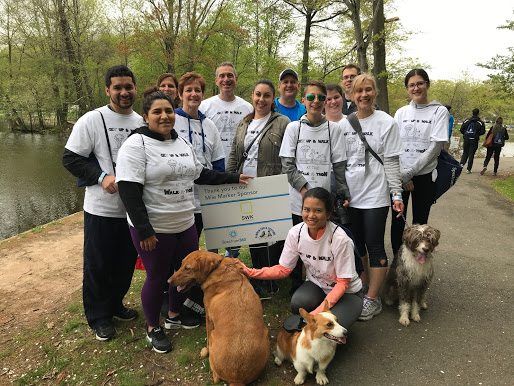 A group of people and dogs posing for a picture.