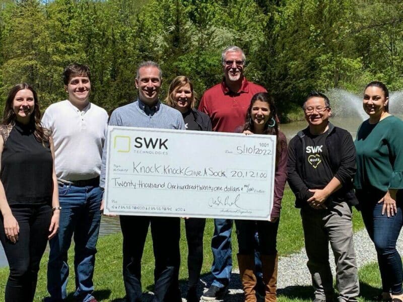 A group of people posing for a picture with a check.