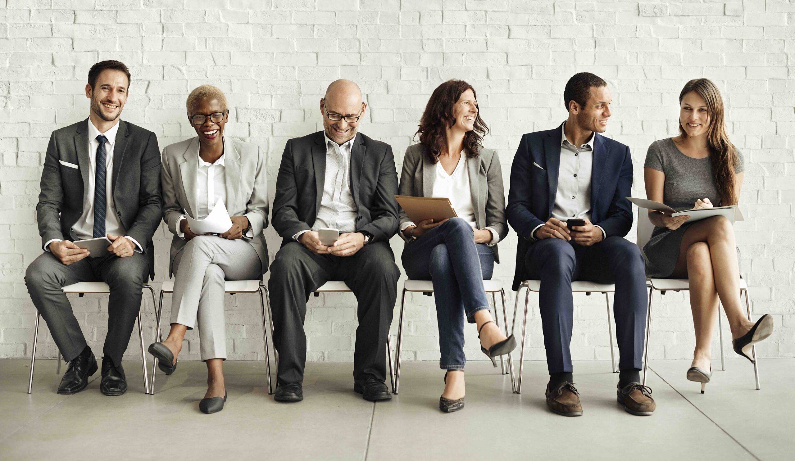 A group of business people sitting in a row.