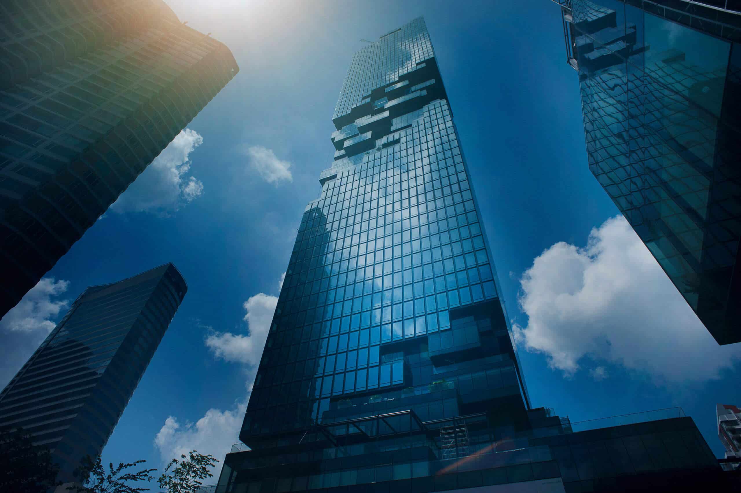 A skyscraper with a blue sky in the background.