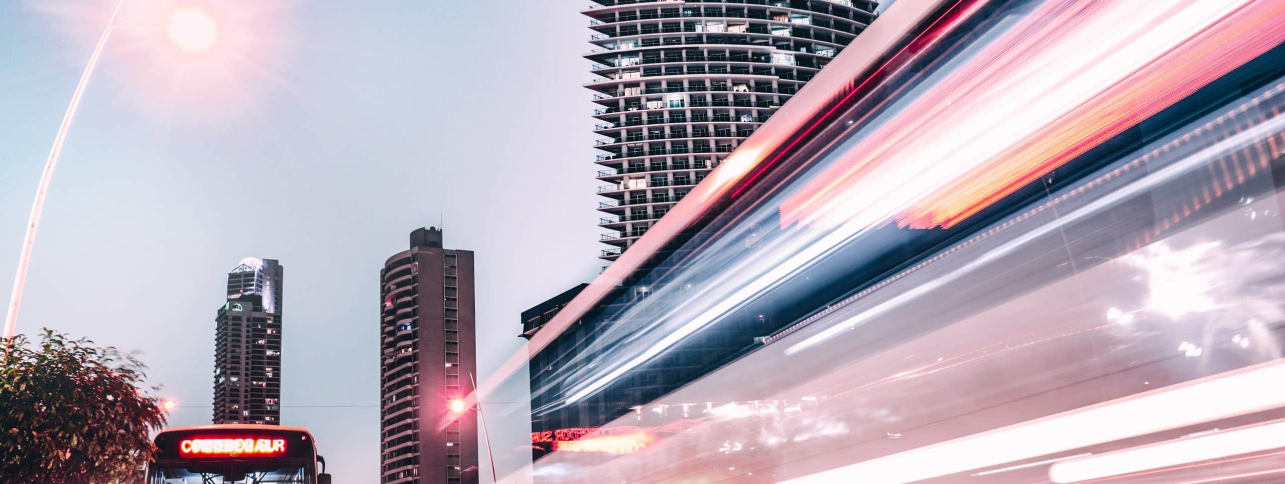 A blurry image of a bus driving down a city street.