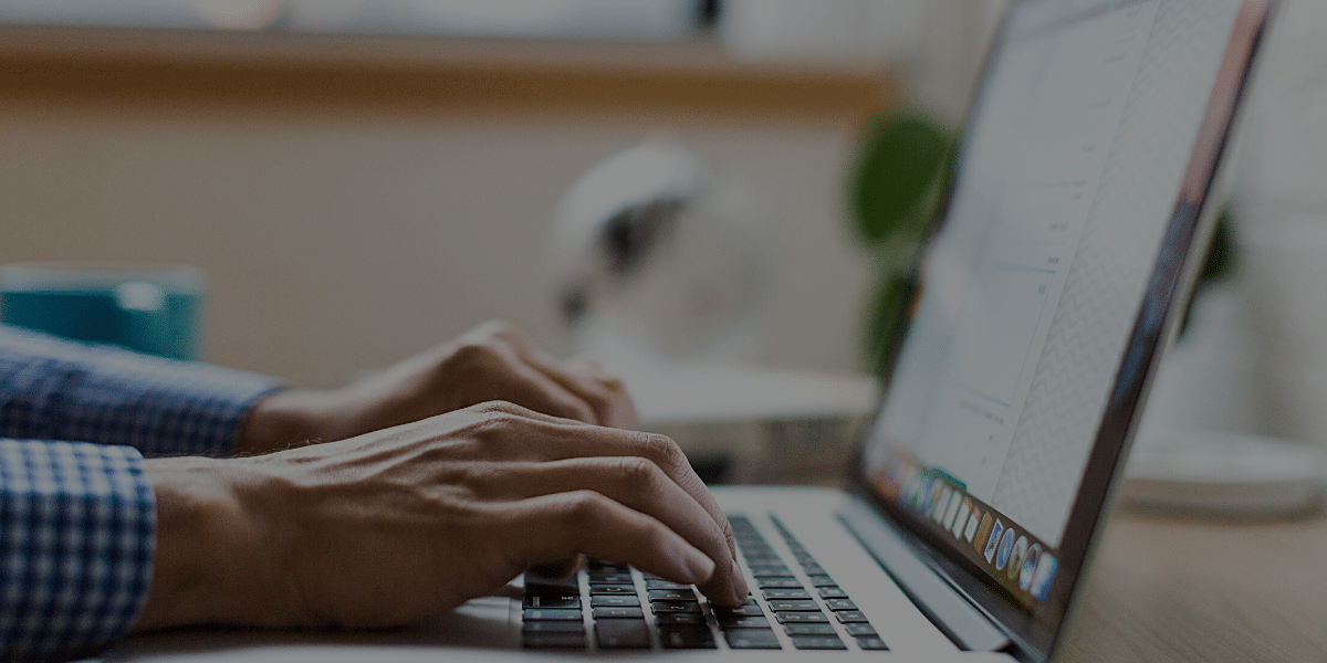 A person typing on a laptop.