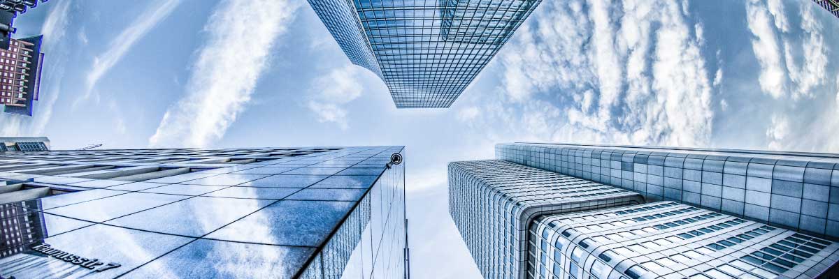 A view of a city with tall buildings and a blue sky.