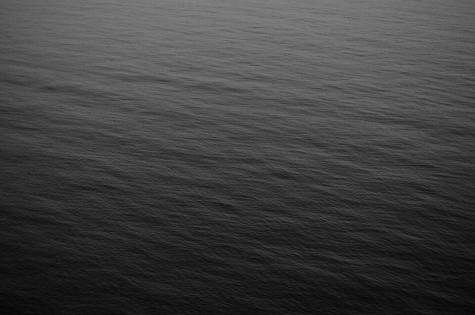A black and white photo of the ocean.