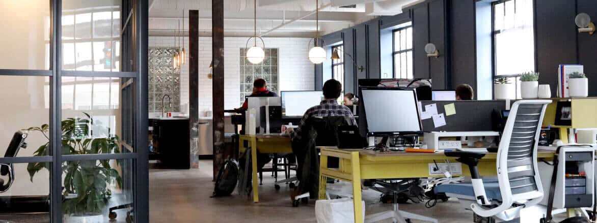 A group of people working at desks in an office.