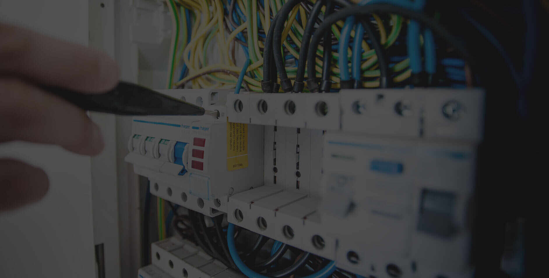 A person is working on an electrical panel.