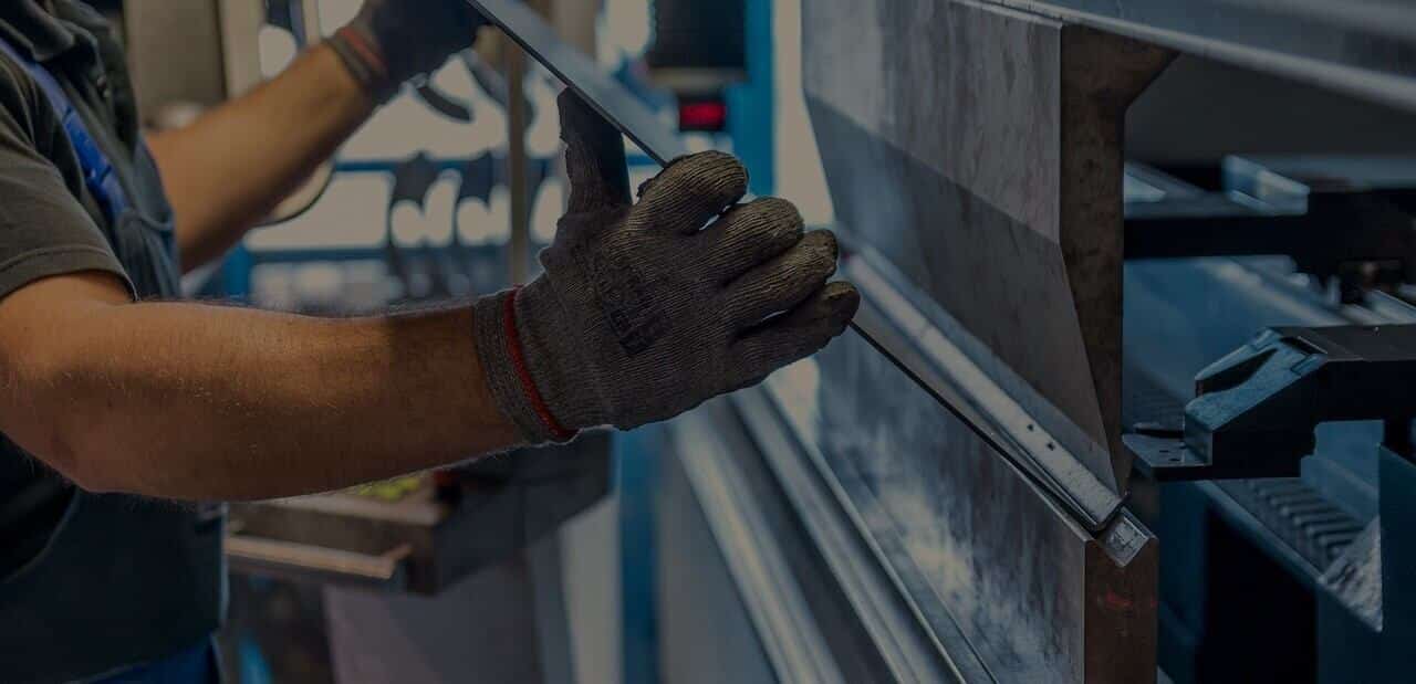 A man is working on a machine in a factory.