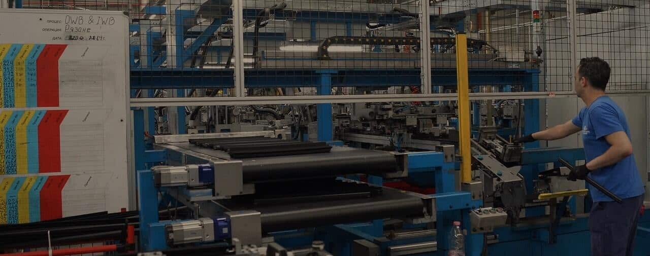 A man is working on a machine in a factory.