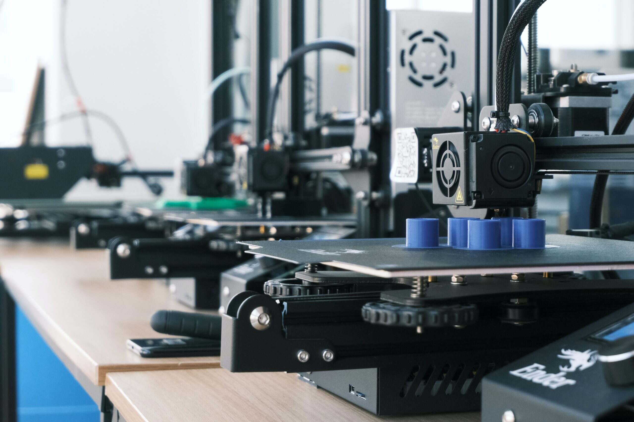 A line of 3D printers in a factory.