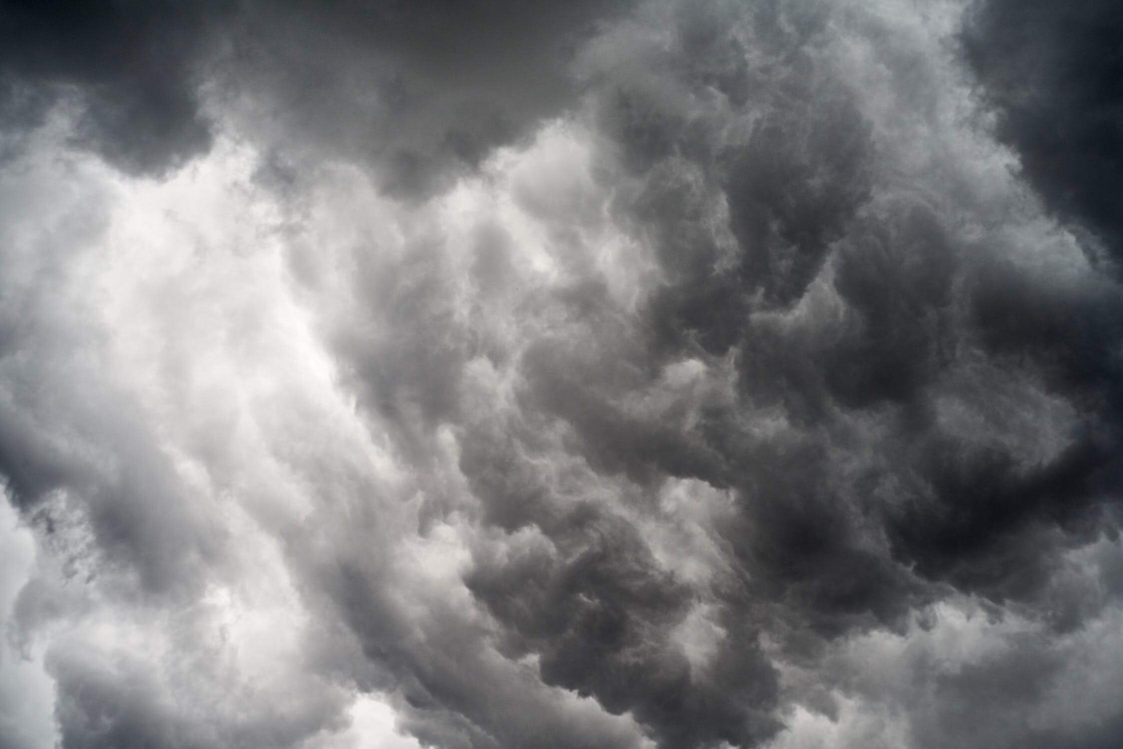 A dark cloudy sky with many dark clouds.