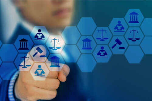 A businessman is pointing at a blue screen with icons of law and justice.
