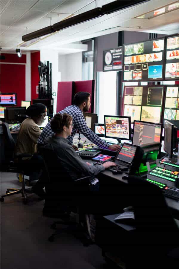 A group of people working in a television studio.