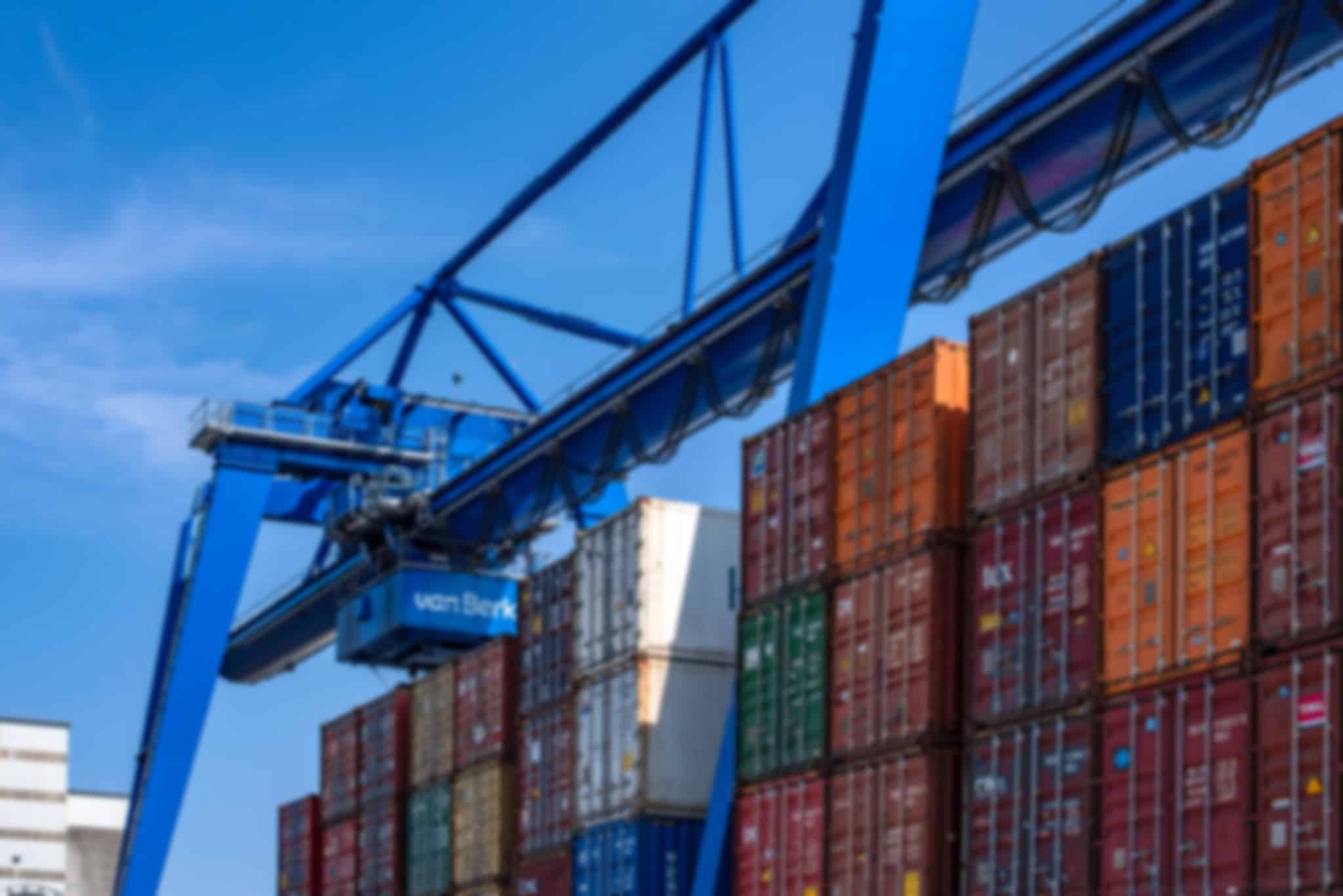 A crane lifts a large number of containers.