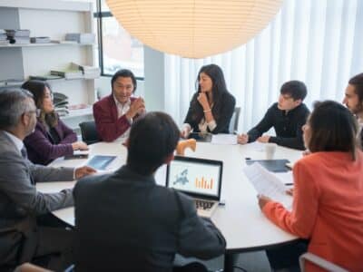 A group of business people sitting around a conference table.