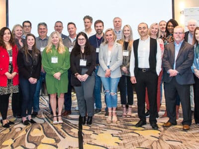 A group of people posing for a photo in a conference room.