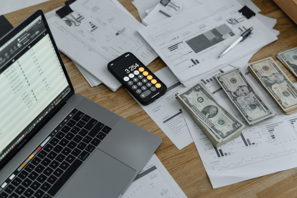 Period and year-end closing activities before using Acumatica; U.S. cash and calculate over paper forms with laptop on left