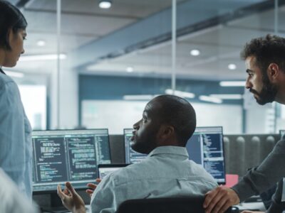 A group of people working on computers in an office.