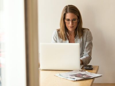 A woman sitting at a desk using a laptop.