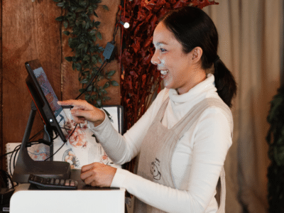 A woman in an apron is working at a counter.