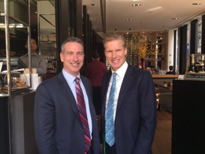 Two men in suits standing next to each other.