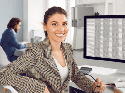 A woman sitting at a desk in front of a computer.