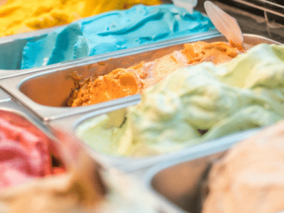 A variety of ice cream flavors in trays.