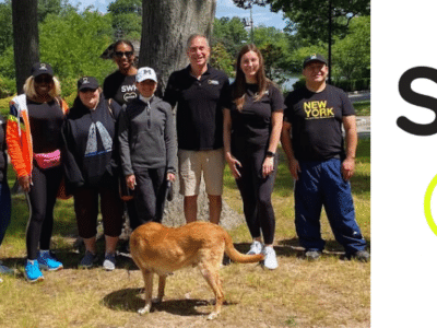 A group of people with a dog posing for a picture.