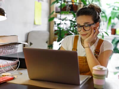 A woman sitting in front of a laptop.