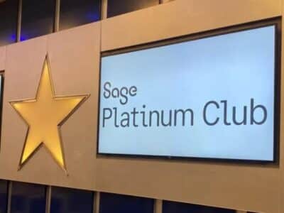 The Sage platinum club logo is displayed on a wall.