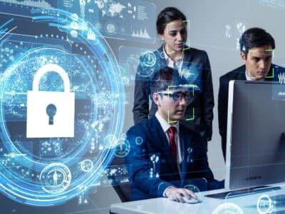 A group of people working on a computer with a padlock on it.