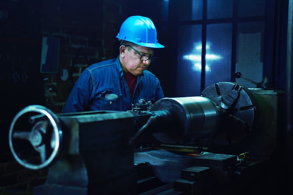 Blog header image showing a man with manufacturing machinery for the Sneak Peek into Sage Production Management and IRP blog by SWK Tech