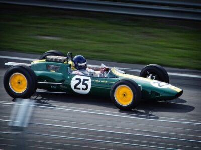 A green and yellow racing car on a track.