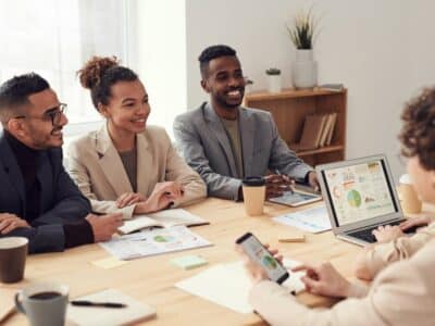 A group of business people sitting around a table.