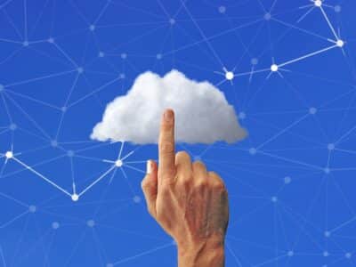 A hand is pointing at a cloud on a blue background.