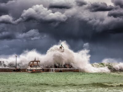 A large wave crashing over a lighthouse.