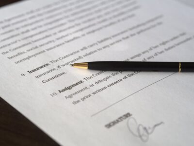 A pen sits on top of a document.