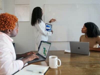 A group of people sitting around a table in a conference room.