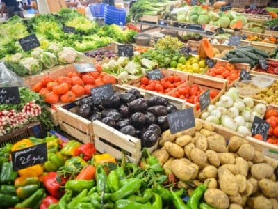 A variety of fruits and vegetables are on display at a market.