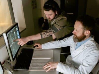 Two doctors looking at a computer screen.