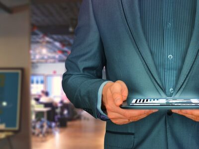 A man in a suit holding a cell phone.