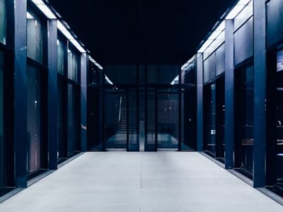 A dark hallway with glass doors and windows.