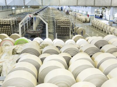 Rolls of white paper in a factory.