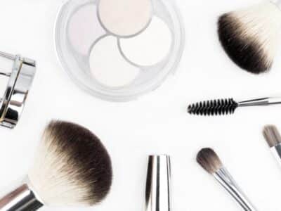 Various makeup brushes arranged on a white background.