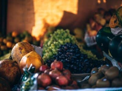 A variety of fruits and vegetables are on display at a market.