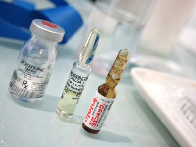 A syringe, syringes, and syringes sit on a table.