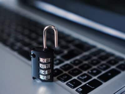 A padlock sitting on top of a laptop.