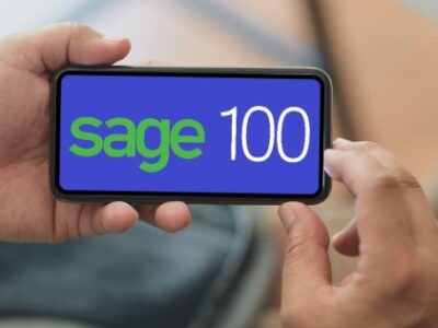 A person holding up a phone with the word Sage 100 on it.