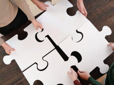 A group of people working together on a puzzle piece.