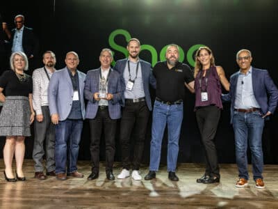 A group of people posing for a picture on stage.